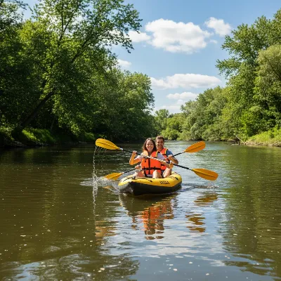 Two people enjoying paddling a bright yellow Intex Explorer K2 inflatable kayak on a wide, calm river.