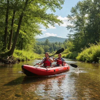 A red Sea Eagle SE370 inflatable kayak with two paddlers navigating a gently flowing river.